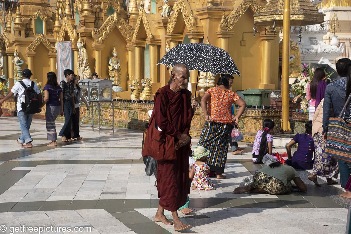 Monk with umbrella on the pagoda platform